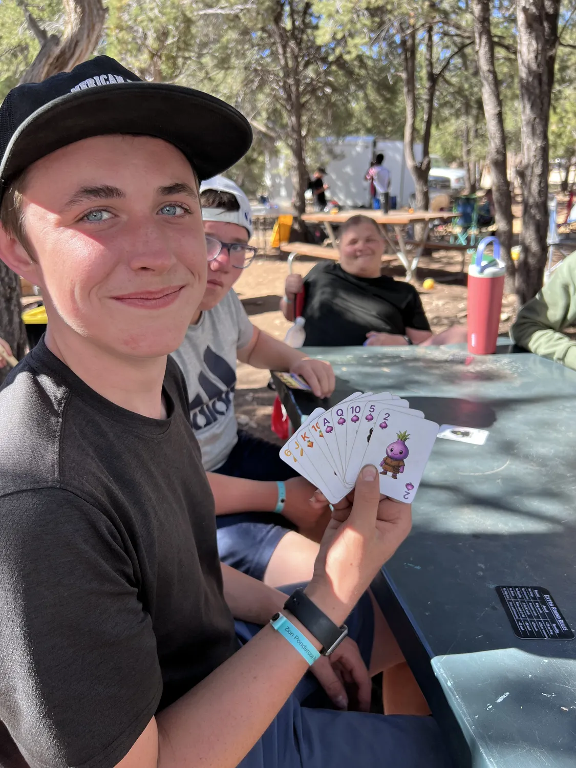 Family playing Skip the Salad around a campfire